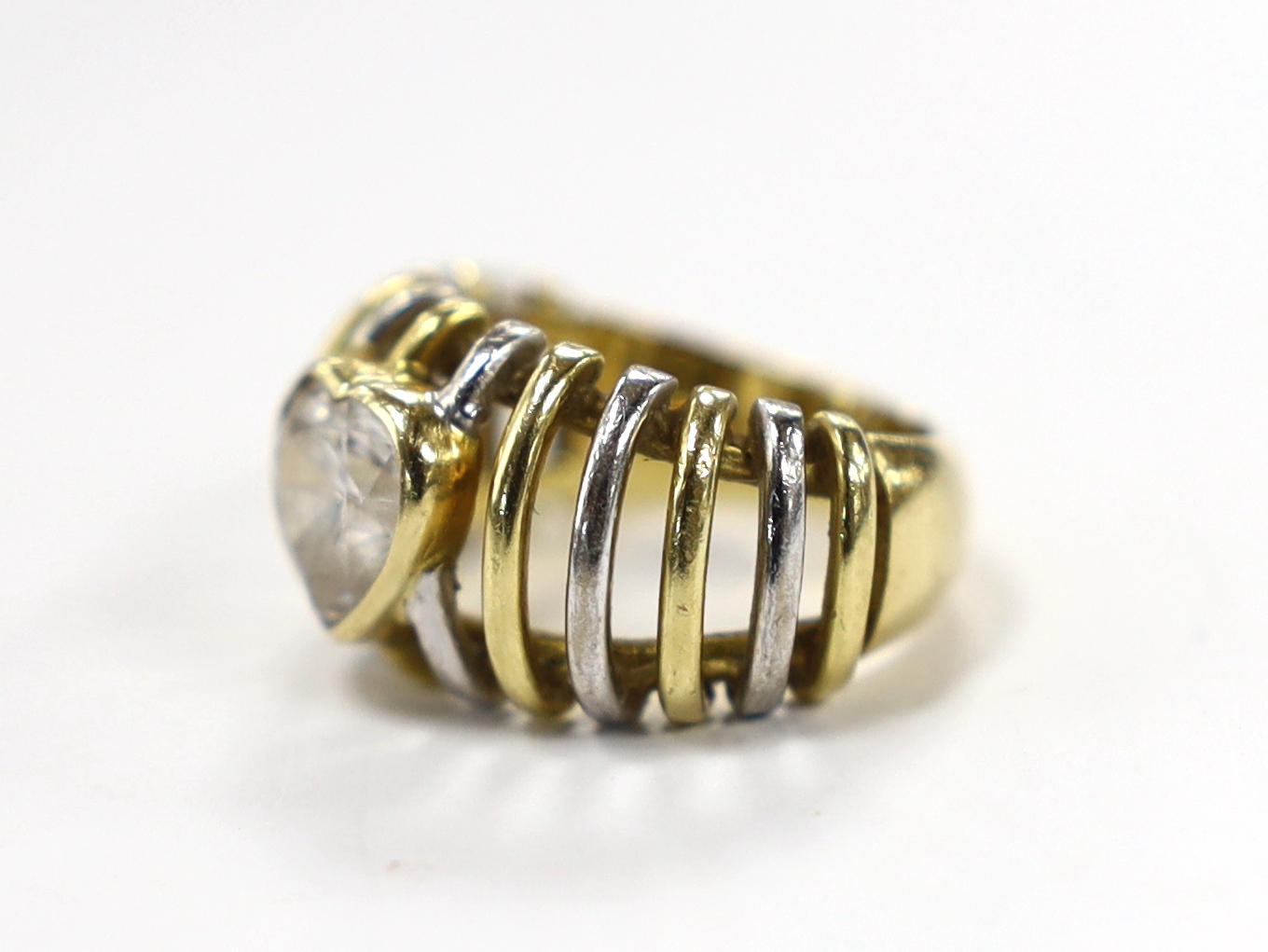 A modern pierced two colour 750 and single stone heart shaped simulated diamond set ring, size K, gross weight 9.4 grams.